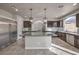Open kitchen design with dark cabinetry, stainless steel appliances, and a large center island at 9876 Parador Cellars Ct, Las Vegas, NV 89141