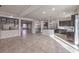 Bright open-concept kitchen with stainless steel appliances, dark cabinetry, and a large center island at 9876 Parador Cellars Ct, Las Vegas, NV 89141