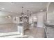 Open-concept kitchen with stainless steel appliances, dark cabinetry, a large island and access to living area at 9876 Parador Cellars Ct, Las Vegas, NV 89141