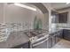Close-up of a kitchen with a mosaic backsplash, stainless steel gas range, and dark granite countertops at 9876 Parador Cellars Ct, Las Vegas, NV 89141