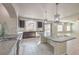 Well-lit kitchen showcasing dark cabinetry, stainless steel appliances, and an island with granite countertop at 9876 Parador Cellars Ct, Las Vegas, NV 89141