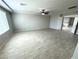 Spacious, light-filled living room featuring wood-look tile flooring and a ceiling fan at 9876 Parador Cellars Ct, Las Vegas, NV 89141