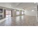 Bright living room featuring neutral tile flooring, recessed lighting, and sliding glass door at 9876 Parador Cellars Ct, Las Vegas, NV 89141