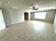 Bright, airy living room featuring wood-look tile floor and a ceiling fan at 9876 Parador Cellars Ct, Las Vegas, NV 89141