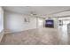 Spacious living room featuring neutral tile flooring, ceiling fans, and an elegant built-in aquarium at 9876 Parador Cellars Ct, Las Vegas, NV 89141