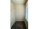 Spacious walk-in closet featuring carpeted floors, shelving, and natural light from the window at 9876 Parador Cellars Ct, Las Vegas, NV 89141