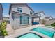 Backyard featuring a covered patio, pool, and well-maintained landscaping for outdoor enjoyment at 9935 Fletcher Peak Ave, Las Vegas, NV 89178