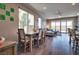 Dining space flows into living area with backyard views, wood floors and contemporary decor at 9935 Fletcher Peak Ave, Las Vegas, NV 89178