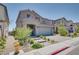 Beautiful two-story home with desert landscaping, paved driveway, and a view of the neighborhood at 9935 Fletcher Peak Ave, Las Vegas, NV 89178