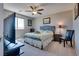 Bedroom featuring large window, neutral colors, and standard furnishings at 9935 Fletcher Peak Ave, Las Vegas, NV 89178