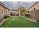 Private backyard featuring a putting green, covered patio with seating, perfect for leisure at 10217 Queens Church Ave, Las Vegas, NV 89135