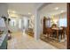 Welcoming dining room with wood furnishings, adjacent to tiled entrance and other rooms at 10217 Queens Church Ave, Las Vegas, NV 89135