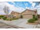 Charming single-story stucco home with a well-manicured lawn and two-car garage at 10217 Queens Church Ave, Las Vegas, NV 89135