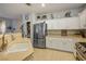 Bright kitchen featuring white cabinetry, stainless steel appliances, and a pantry at 10217 Queens Church Ave, Las Vegas, NV 89135