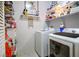 Functional laundry room with a modern washer and dryer, plus ample shelving for storage at 10217 Queens Church Ave, Las Vegas, NV 89135