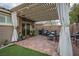 Relaxing outdoor patio featuring a pergola, seating, and decorative lighting at 10217 Queens Church Ave, Las Vegas, NV 89135