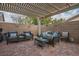 Relaxing outdoor patio with stylish seating under a pergola, ideal for entertaining at 10217 Queens Church Ave, Las Vegas, NV 89135