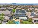 Aerial view of a home with solar panels, a private pool, and a covered patio in a suburban neighborhood at 10662 Bonchester Hill St, Las Vegas, NV 89141