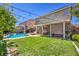 Large backyard with pergola, dining table and lush green lawn and in-ground pool at 10662 Bonchester Hill St, Las Vegas, NV 89141