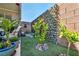Charming backyard oasis with a cozy lounge area and lovely green wall at 10662 Bonchester Hill St, Las Vegas, NV 89141