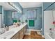 Bright bathroom offering double sinks, spacious vanity, and a tiled shower-tub combo with modern fixtures at 10662 Bonchester Hill St, Las Vegas, NV 89141