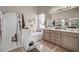 Bathroom with a glass enclosed shower, large soaking tub, and double sinks with lots of counter space at 10662 Bonchester Hill St, Las Vegas, NV 89141