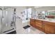 Bathroom featuring a bathtub, standing shower, and double sinks at 10662 Bonchester Hill St, Las Vegas, NV 89141