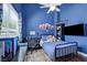 Blue bedroom featuring a ceiling fan, a window, and wall art at 10662 Bonchester Hill St, Las Vegas, NV 89141