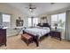 Bright bedroom with multiple windows, a ceiling fan, and a view of the neighborhood at 10662 Bonchester Hill St, Las Vegas, NV 89141