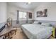 Cozy bedroom featuring neutral-colored walls, a large window and side table at 10662 Bonchester Hill St, Las Vegas, NV 89141