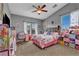 Charming bedroom with whimsical decor, soft lighting, and ample play space at 10662 Bonchester Hill St, Las Vegas, NV 89141