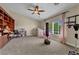 Bright bedroom with high ceilings, built-in shelving, and neutral carpet flooring at 10662 Bonchester Hill St, Las Vegas, NV 89141
