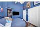 Blue bedroom with a large closet, ceiling fan, wall art, and wood-look floors at 10662 Bonchester Hill St, Las Vegas, NV 89141