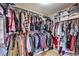 Walk-in closet with ample hanging space and upper shelves for storage and organization at 10662 Bonchester Hill St, Las Vegas, NV 89141