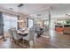 Bright dining room with elegant chandelier and mirror wall, seamlessly flowing into the adjacent living area at 10662 Bonchester Hill St, Las Vegas, NV 89141