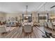 Spacious dining area features stylish decor, wood-look floors, a large mirror and plenty of natural light at 10662 Bonchester Hill St, Las Vegas, NV 89141