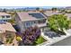 Two-story home featuring an attached garage, well-maintained landscaping, and potential energy-saving solar panels at 10662 Bonchester Hill St, Las Vegas, NV 89141