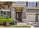 Charming home with a welcoming double-door entrance, lush greenery, and a well-maintained lawn at 10662 Bonchester Hill St, Las Vegas, NV 89141