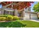 Inviting home exterior showcasing a well-manicured lawn, lush landscaping, and a welcoming front entrance at 10662 Bonchester Hill St, Las Vegas, NV 89141
