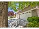 A spacious three-car garage and well-kept landscaping enhance this home's curb appeal at 10662 Bonchester Hill St, Las Vegas, NV 89141
