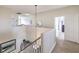 Upstairs hallway with carpet and tile floors and neutral paint at 10662 Bonchester Hill St, Las Vegas, NV 89141