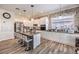 Stylish kitchen with white cabinetry, granite countertops, and a central island with bar seating at 10662 Bonchester Hill St, Las Vegas, NV 89141
