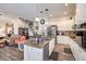 Kitchen with a spacious granite island and stainless steel appliances adjacent to the living room at 10662 Bonchester Hill St, Las Vegas, NV 89141