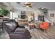 Cozy living room with a fireplace, leather sofas, and a staircase leading upstairs at 10662 Bonchester Hill St, Las Vegas, NV 89141