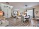 Open-concept living and dining area featuring wood floors, a skylight, and contemporary decor at 10662 Bonchester Hill St, Las Vegas, NV 89141