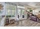 Light-filled living area with French doors to the backyard, featuring a cozy fireplace and modern flooring at 10662 Bonchester Hill St, Las Vegas, NV 89141