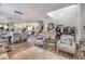 Large open living space with wood-look floors, staircase, dining area, and comfortable seating at 10662 Bonchester Hill St, Las Vegas, NV 89141