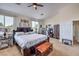 Spacious main bedroom with a ceiling fan, a king bed, and carpet floors at 10662 Bonchester Hill St, Las Vegas, NV 89141