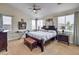 Cozy main bedroom featuring a ceiling fan, a king bed, and natural light at 10662 Bonchester Hill St, Las Vegas, NV 89141