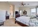 Comfortable main bedroom featuring a ceiling fan, neutral colors, and natural light at 10662 Bonchester Hill St, Las Vegas, NV 89141